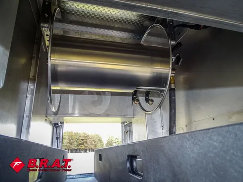 Compartment close-up with mounted metal hose reel.