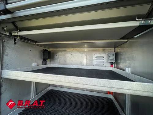Upper shelf view inside a long aluminum side compartment.