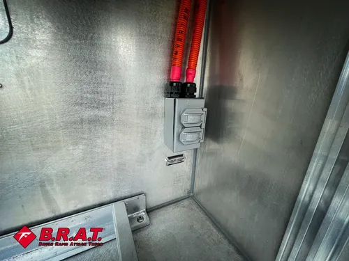 Close-up of compartment wall with a red vertical release handle.