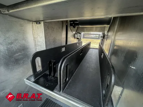 Close-up inside pump bay showing black divider plates and piping.