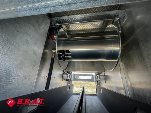 Metal cylindrical tank mounted inside the pump compartment.