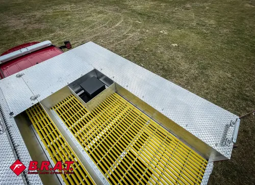 Top view of rear hatch area with yellow grate and lid hardware.