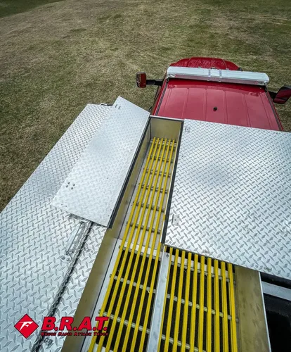 Rear platform walkway with open hatch and center yellow drainage grate.