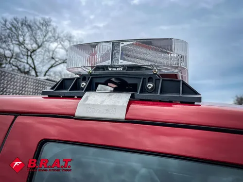 Roof rack mount and warning light bar base on the cab roof.