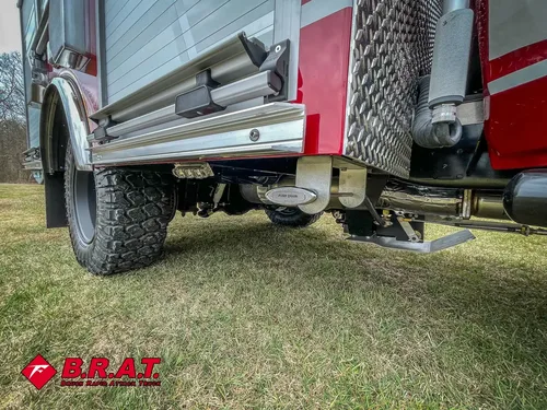 Low side angle showing step area and underbody near rear wheel.