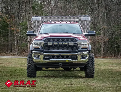 Head-on front view with grille, bumper, and light bar.