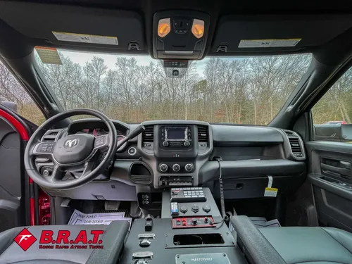 Front cabin view from rear seats showing dashboard and controls.