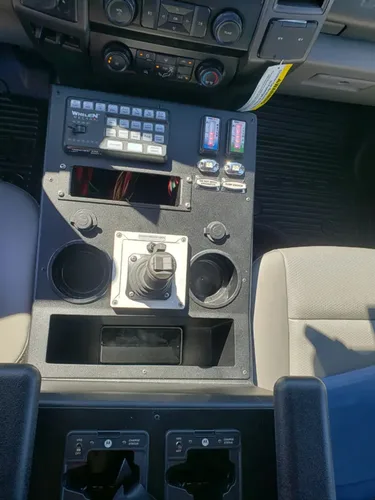 Exterior view of small fire truck showing cab, body compartments, and wheel/tire area.