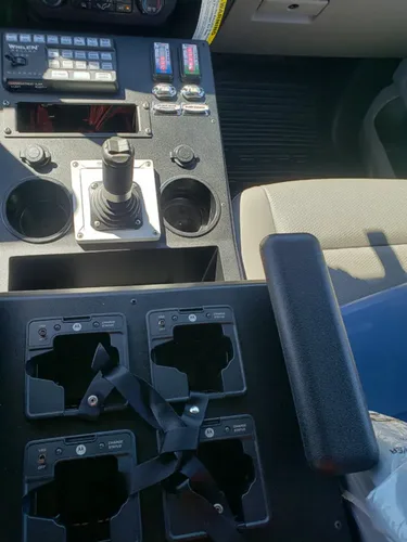 Exterior view of small fire truck showing cab, body compartments, and wheel/tire area.