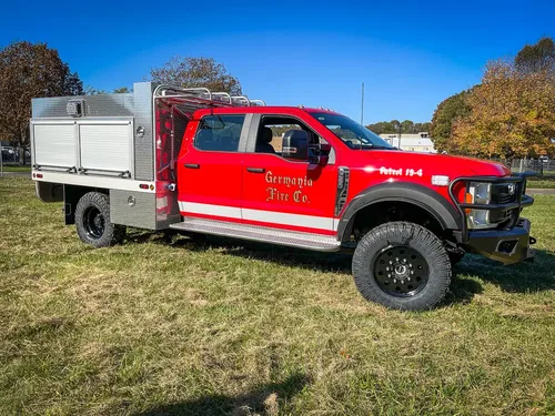 Front-right three-quarter view of truck with utility body.