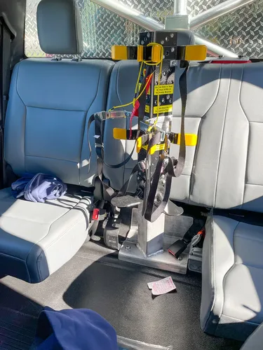 Rear seating close-up with mounted equipment bracket between seats.