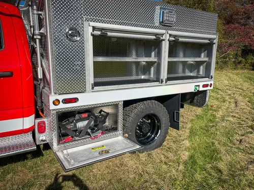 Rear side compartment open showing shelf storage and lower bay.