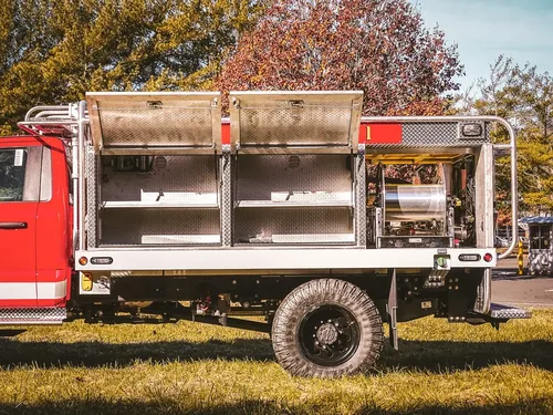 Rear-right side with upper compartment doors raised and shelves visible.
