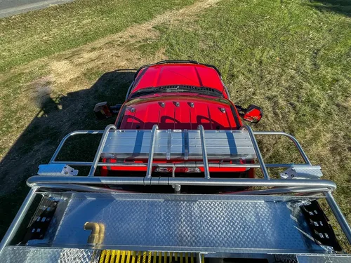 Top deck near cab showing handrails and red cab roof.