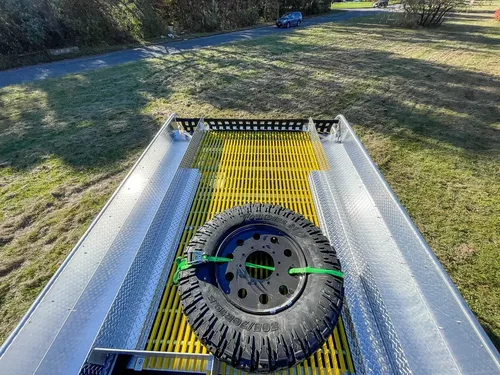 Top deck view with spare tire and yellow center walkway.