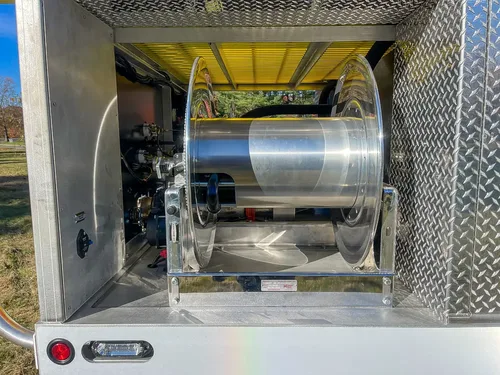 Rear compartment with hose reel assembly mounted inside.