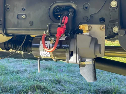 Underbody side close-up with mounted red connector and electrical hardware.