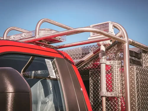 Rear cab rack and side rail close-up above utility body.