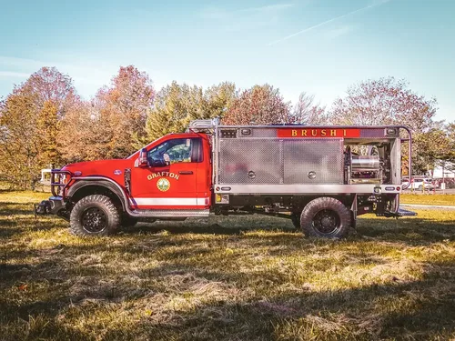 Full right-side profile of truck parked on grass.