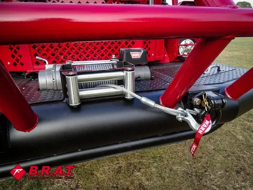 Exterior view of small fire truck showing cab, body compartments, and wheel/tire area.