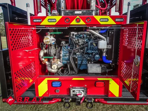 Exterior view of small fire truck showing cab, body compartments, and wheel/tire area.