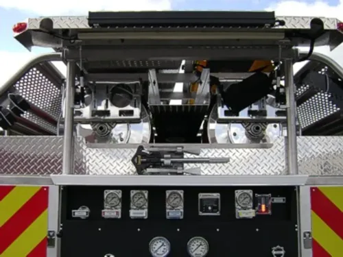 Exterior view of small fire truck showing cab, body compartments, and wheel/tire area.