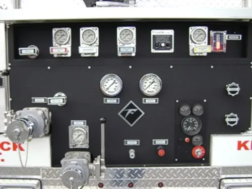 Exterior view of small fire truck showing cab, body compartments, and wheel/tire area.