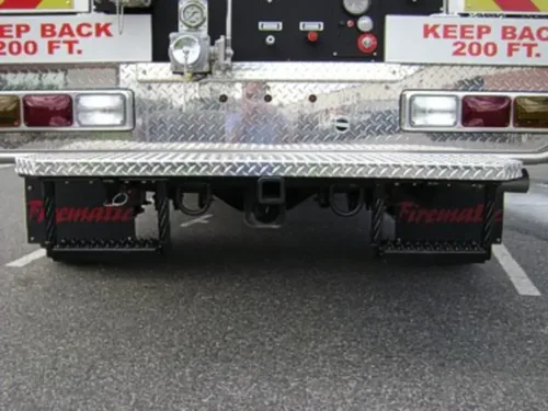 Exterior view of small fire truck showing cab, body compartments, and wheel/tire area.
