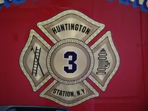 Exterior view of small fire truck showing cab, body compartments, and wheel/tire area.