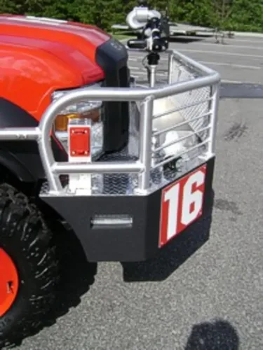 Exterior view of small fire truck showing cab, body compartments, and wheel/tire area.