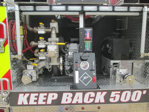 Exterior view of small fire truck showing cab, body compartments, and wheel/tire area.