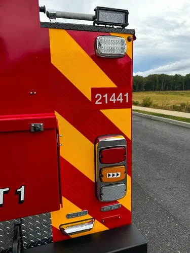 Rear corner close-up with taillight and unit number.