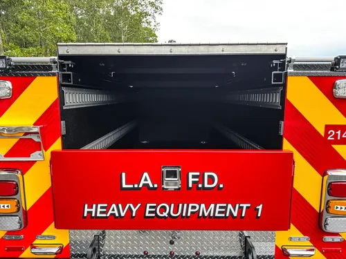 Rear cargo opening with upper door lifted.