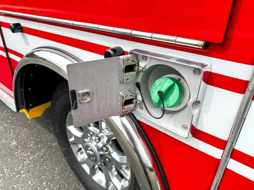 Close-up of green-capped fuel inlet on side panel.