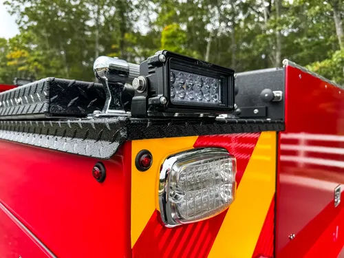 Rear corner top rack with mounted light bar assembly.