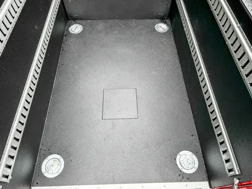Cargo bed floor view with circular tie-down points.