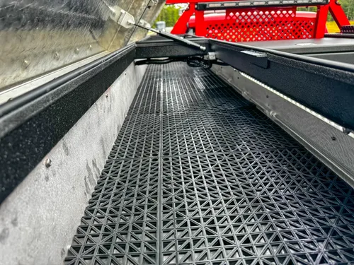 Extended bed rail storage channel with grated floor.