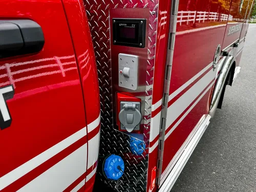 Vertical side panel with connectors and controls near cab.