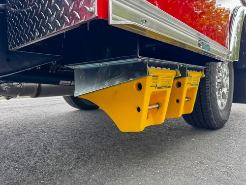 Underside yellow equipment mount beneath side body.