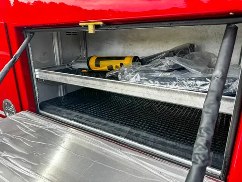 Open side drawer compartment with wrapped shelf insert.