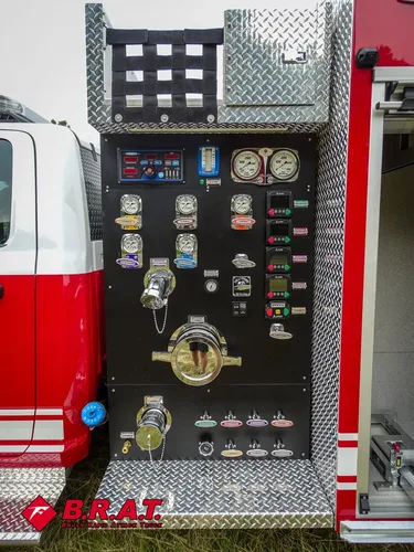 Exterior view of small fire truck showing cab, body compartments, and wheel/tire area.