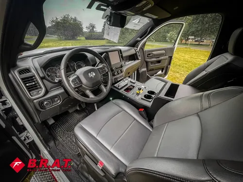 Exterior view of small fire truck showing cab, body compartments, and wheel/tire area.