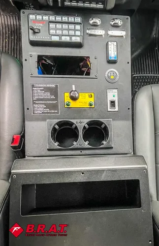 Exterior view of small fire truck showing cab, body compartments, and wheel/tire area.