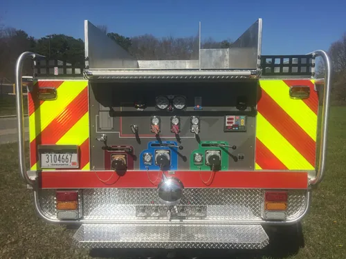 Exterior view of small fire truck showing cab, body compartments, and wheel/tire area.