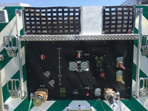 Exterior view of small fire truck showing cab, body compartments, and wheel/tire area.