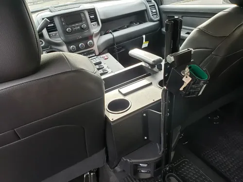 Exterior view of small fire truck showing cab, body compartments, and wheel/tire area.