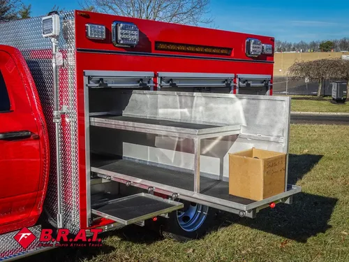 Open side compartment with long slide-out tray extended and box on shelf.