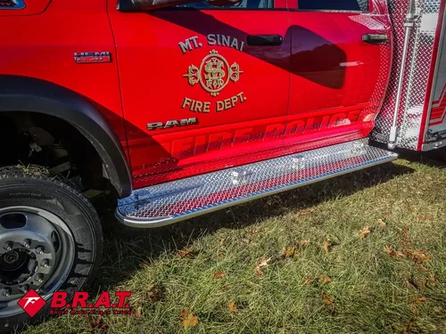 Driver-side cab door and side step close-up with department emblem.