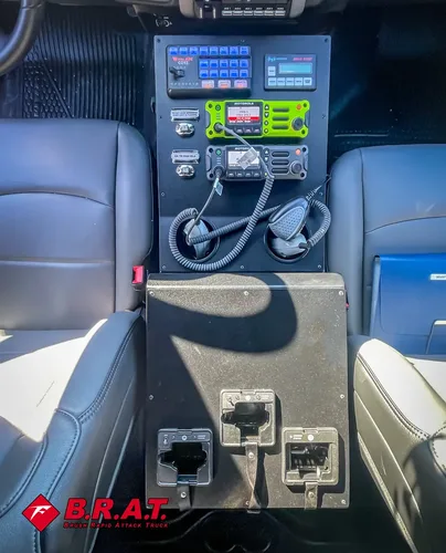 Center control stack close-up with green radio unit and switches.