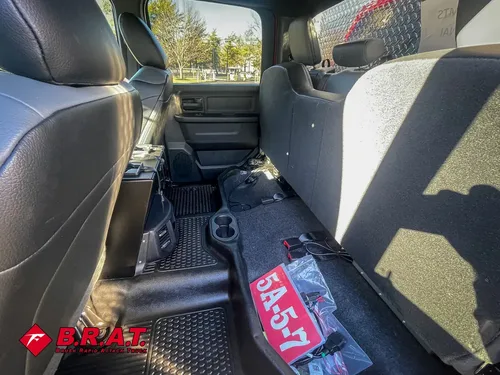 Rear cabin view from left side showing bench and floor controls.